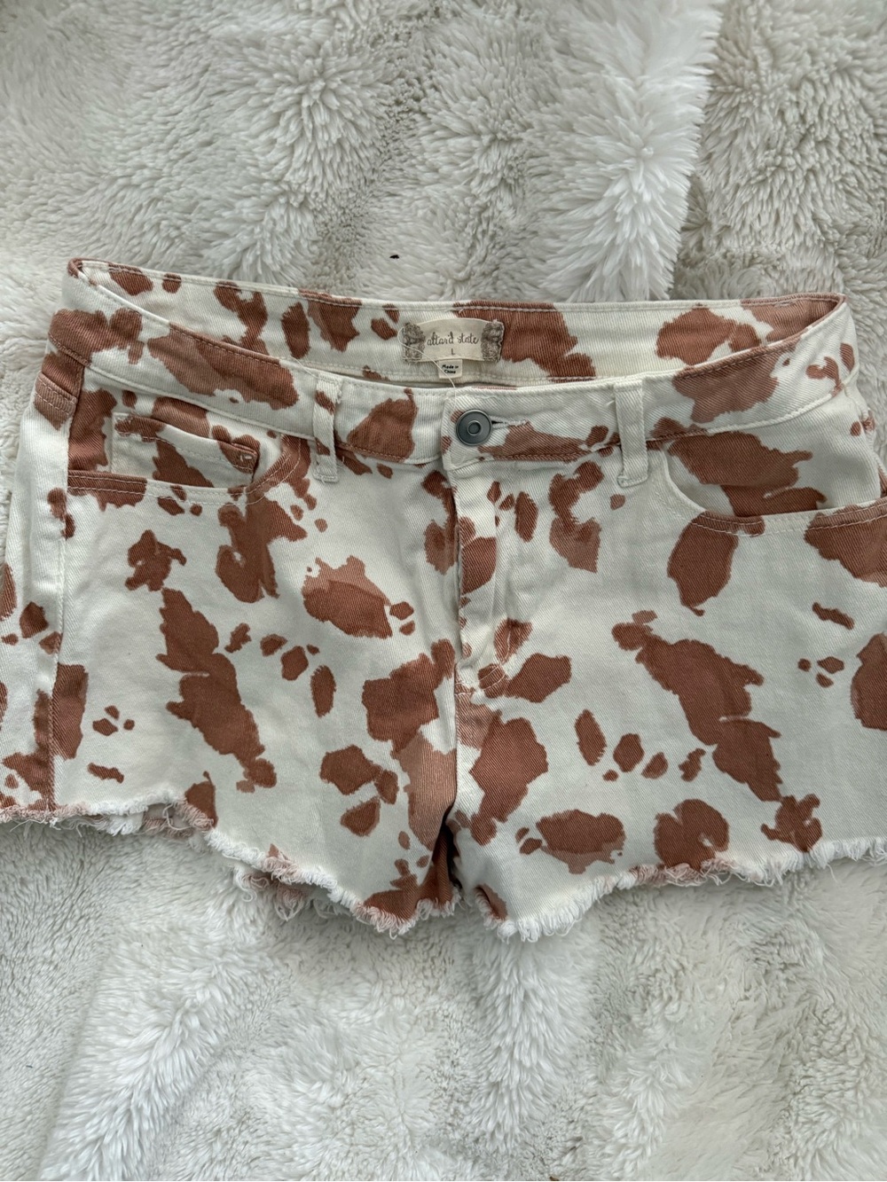 Altar'd State Cream and Rust Cow Print Denim Cutoff Shorts